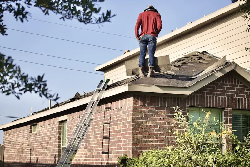 Professional roofer working on a residential roof in Irondale